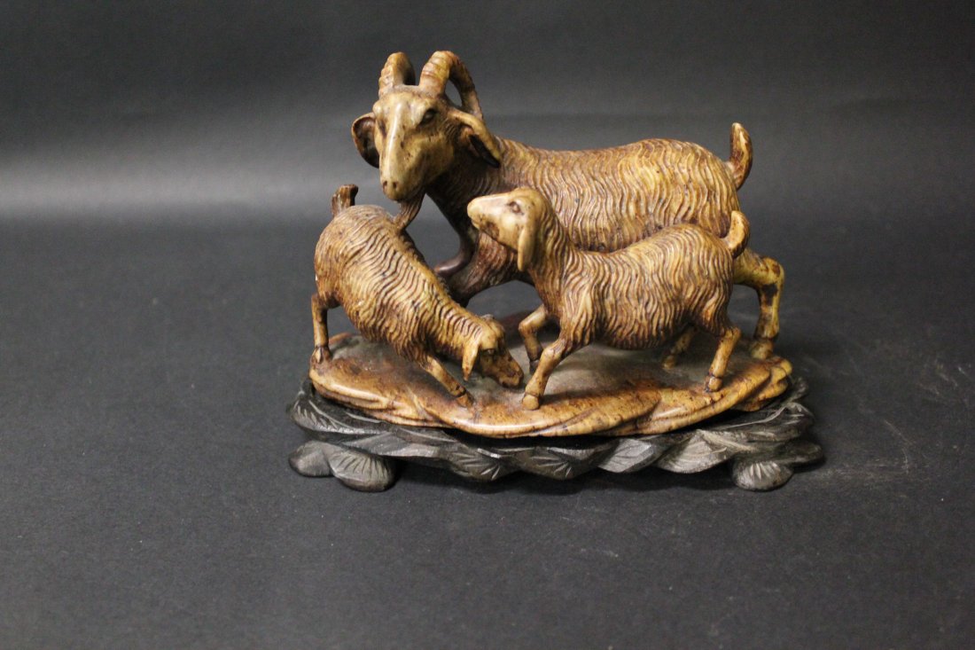 STONE SCULPTURE: A SCULPTURE MADE FROM SOUPSTONE OF THREE RAMS BRINGING BLISS. 20 CM WIDE