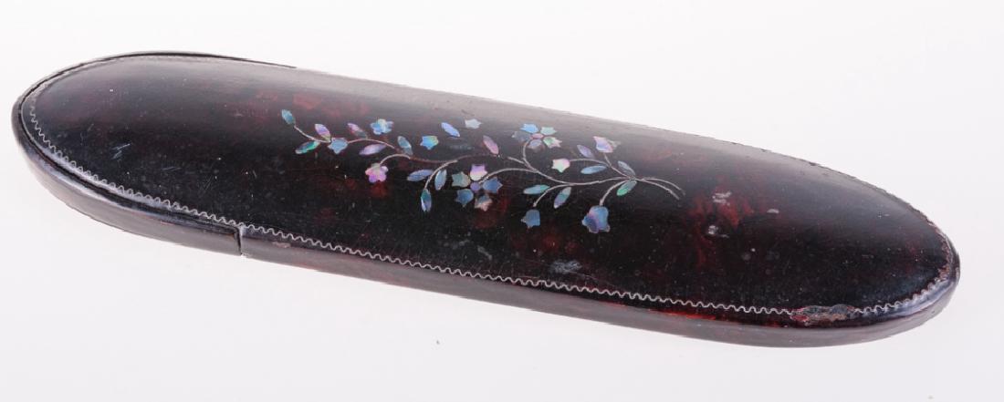 Antique Glasses Case with Abalone Inlay: Lacquered paper mache eye glass case with abalone inlay in a flower motif with velvet lining, circa 19th century. Case measures 6-1/4" long by 1-1/2" wide. All measurements are approximate. In overall