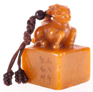 Chinese Carved Jade Milu Stamp: Carved jade Chinese stamp with the figure of a Milu, also known as Père David's deer. A corded tassel with a wooden bead is wound around the deer's antlers. Carved Chinese characters on the side of t