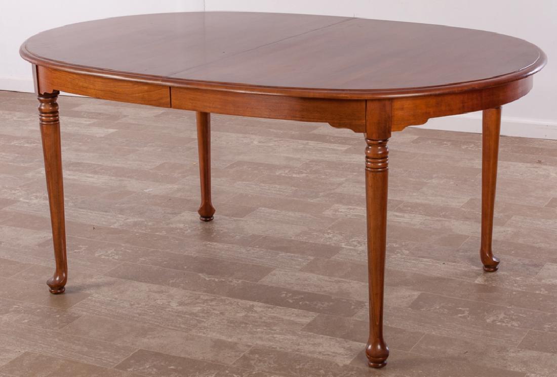 Davis Cabinet Company Cherry Dining Table: Davis Cabinet Company burnished cherry dining table with two leaves; measures approximately 30" high, 44" wide, 63-1/2" in length, each leaf 16". Marked to underside of table with paper label.