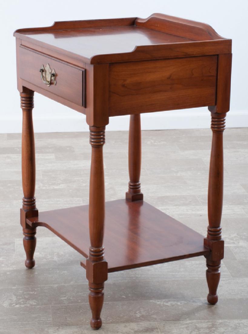 Henkel-Harris Black Cherry Nightstand: Henkel-Harris black cherry nightstand having a single drawer with a brass batwing pull, open bottom shelf and a three-sided gallery to the top; measures approximately 31-1/2” high, 20-3/4” wide an