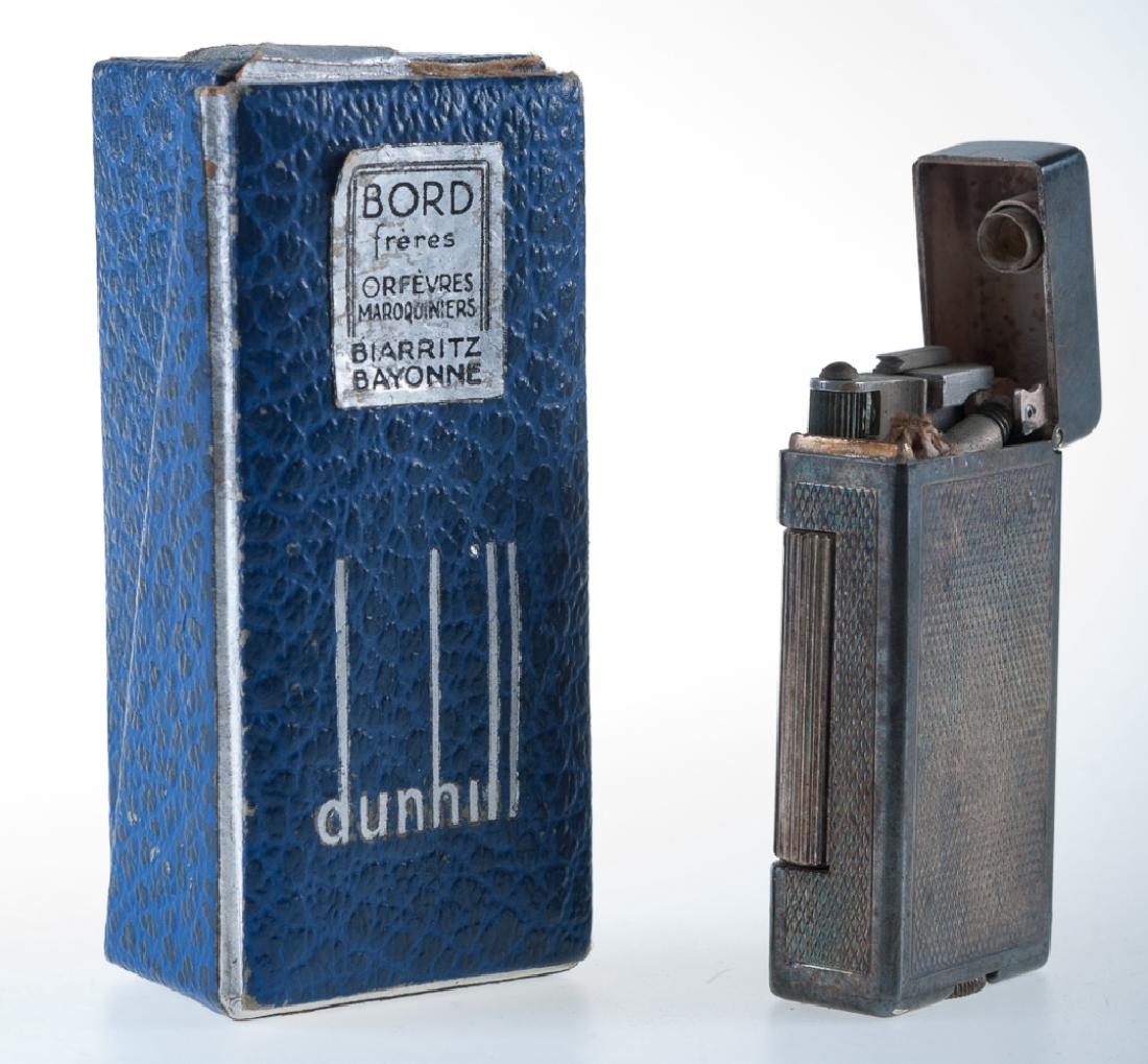 Vintage Dunhill Sterling Lighter: Vintage Dunhill sterling lighter in original box, Early 20th Century, not marked but tests for sterling. Marked to the bottom Dunhill London, Made in Switzerland. Measures approximately 2” high. 1.6