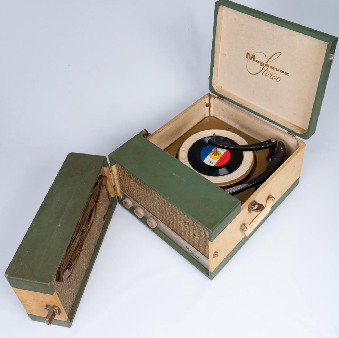 Magnavox Portable 1SC242J Record Player: Magnavox Model 1SC242J portable record player circa 1960 with one attached and on detachable speaker; measures approximately 9-3/8" high, 15" wide and 22" long. Marked with model # and serial number t