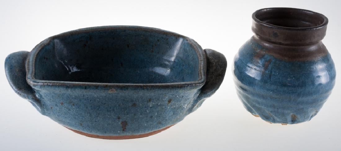 Art Pottery Casserole Dish and Vase: Earthenware art pottery casserole dish and vase each with a blue glaze. Casserole dish measures 2-7/8” high and 10” wide from handle to handle. Vase measures 5” high and 4-1/2” in diameter and
