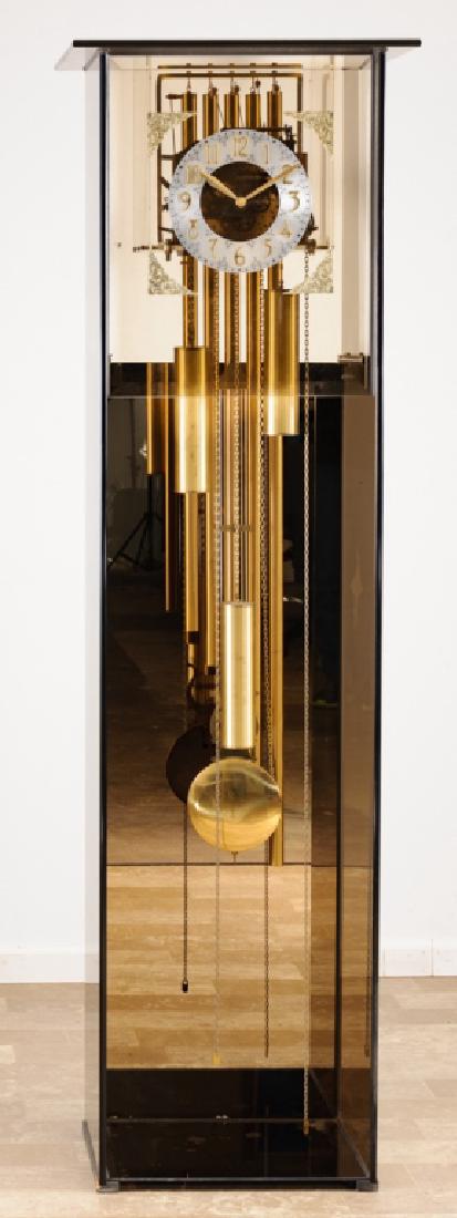 Dykstra Kieninger Contemporary Grandfather Clock: Smoked glass encased grandfather clock by Dykstra Clock Co., Holland, MI., clockworks by Kieninger of Germany; measures approximately 78” high, 23-1/8” wide, and 19” deep. Glass front marked Dyk
