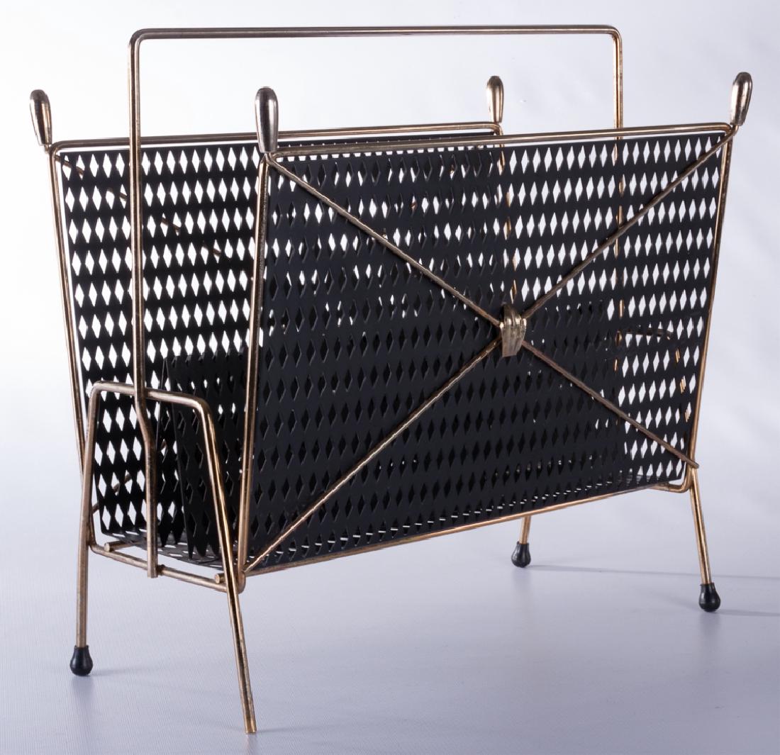 Magazine Rack, Pierced Metal: Magazine rack having a black pierced metal design with brass colored accents, plenty of space for your magazines or LPs; measures approximately 15” high, 8-1/4” wide, and 16” long. One black foo