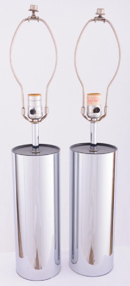 Robert Sonneman Chrome Cylinder Tube Lamps: Pair of chrome cylinder tube table lamps with black enamel tops, each having a three-way socket switch, lamps measure approximately 24” high and 4-1/2” in diameter. Unsigned. Both lamps in good wo