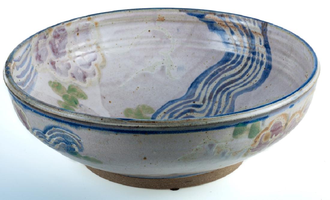 Jim & Lala Howard Earthenware Bowl: Jim & Lala earthenware bowl, hand glazed with a floral motif; measures approximately 4-1/2” high and 13-1/2” in diameter. Signed “Lala 1990” to the side and inscribed “Jim” to the bottom.
