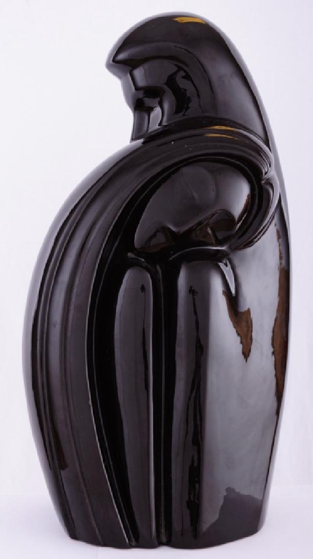 Haeger Embracing Couple #6051 Ceramic Statue: Black ceramic Haeger statue of a couple embracing; measures 17-1/2" in height with width of 8" and 6-1/2" in depth. With original paper label to the bottom of statue indicating "Haeger" with model num