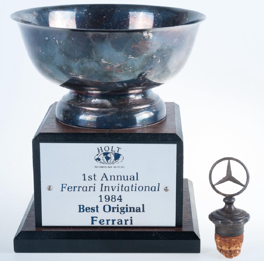 Ferrari Invitational Trophy, Mercedes Accessory: Holt International Motors “1st Annual Ferrari Invitational 1984 Best Original Ferrari” trophy, together with a Mercedes-Benz wine bottle stopper. Trophy measures approximately 6-3/4” high and 5-
