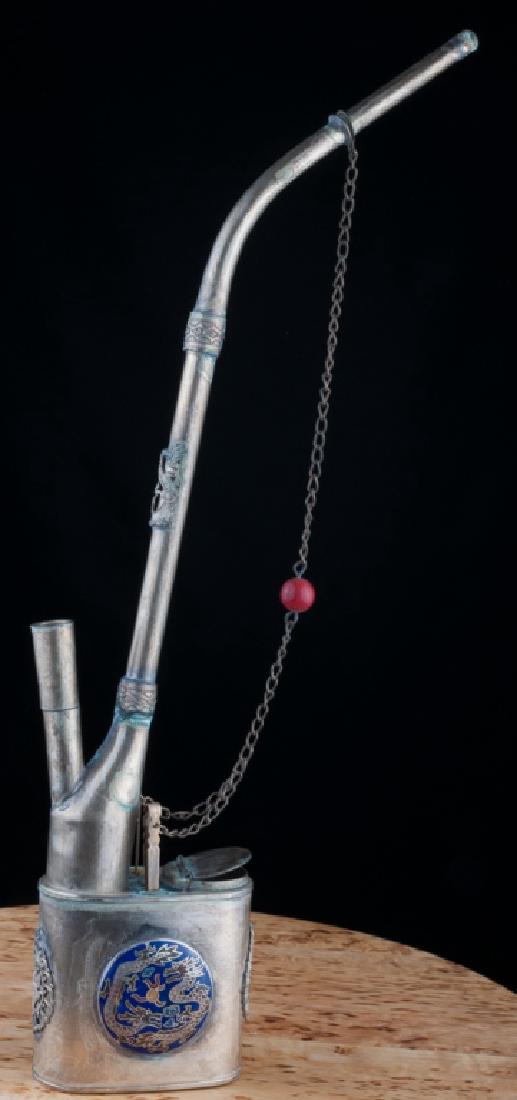 Chinese Opium Smoker’s Kit: Silver colored metal with applied enamel disks and dragons. Contains opium holder, pipe, tweezers, and toothpick; measures 14" in height with width of 5-3/4" and depth of 1-1/4". In good overall condi