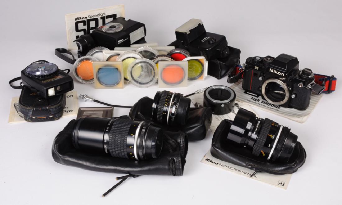Nikon F3 SLR & Accessories: Nikon F3 SLR 35mm camera and accessories of approximately twenty four to include: Nkion F3 35mm camera and instruction manual; Nikon Nikkor 200mm 1:4 manual focus lens with 52 mm UV filter and protect