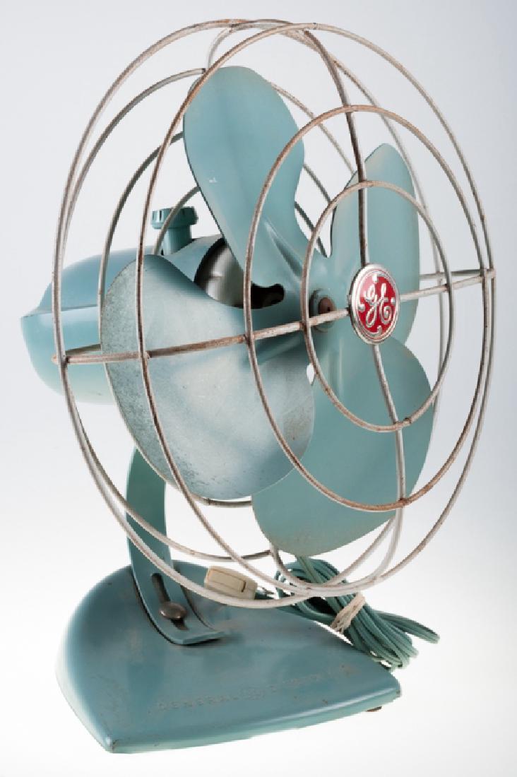 General Electric (GE) Oscillating Fan: General Electric 10" Cat. No F13S107 single speed oscillating desktop four blade metal fan, blue gray base and blades with white cage, circa 1950s; measures approximately 13-3/4" high, 12" cage diamet