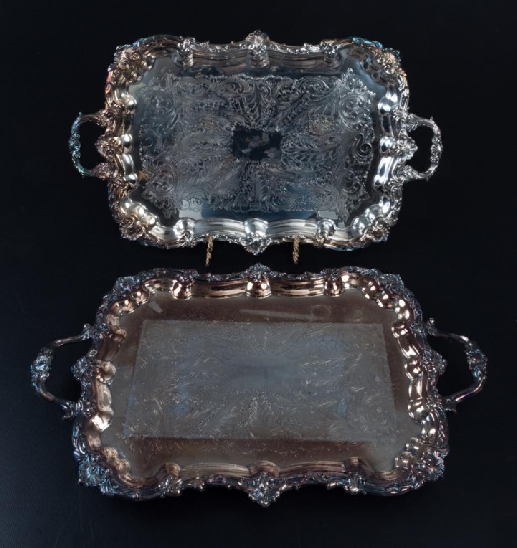 Silver Plated Serving Trays Pair: Two (2) silver plated trays to include: one F.B. Rogers footed serving tray with double handle; measures approximately 14-3/4" wide, and 24-7/8" long, from handle to handle, and makers marked to the b