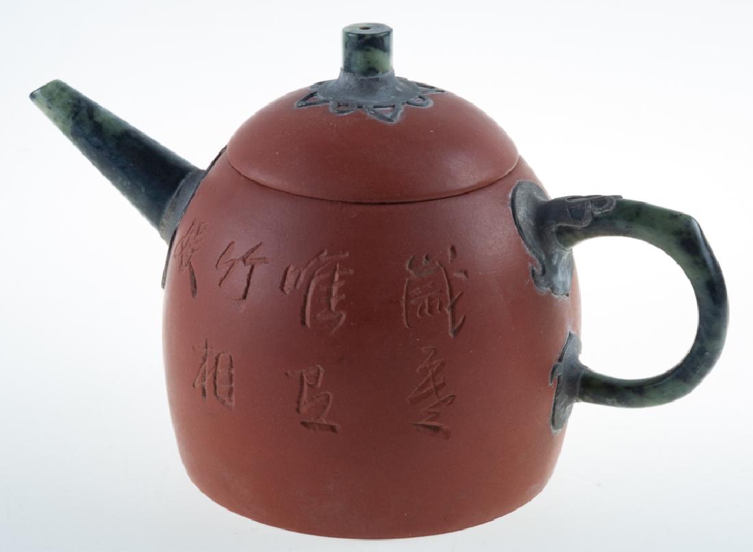 Yixing Zisha Pottery Teapot: Mounted with metal and green stone; possibly jade handle, spout and finial. With incised bamboo and character marks to the body. Marked to the bottom. Teapot measures 4-1/2" in height with width of 7"