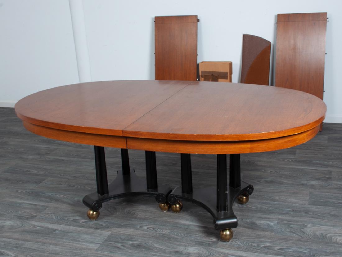 Biedermeier Style Dining Table: Biedermeier style dining table having an ebonized double pedestal base with square tapered columnar supports on brass tone ball feet, includes two leaves. Includes pads for the top. Measures approxima