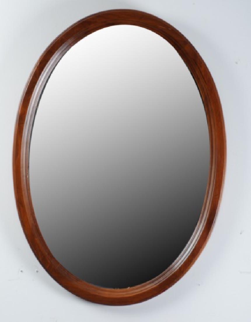 Ethan Allen Oval Wall Mirror: Oval wall mirror having a molded wood frame by Ethan Allen. Marked to the back. Measures approximately 36-1/2â€ high, and 26â€ wide.