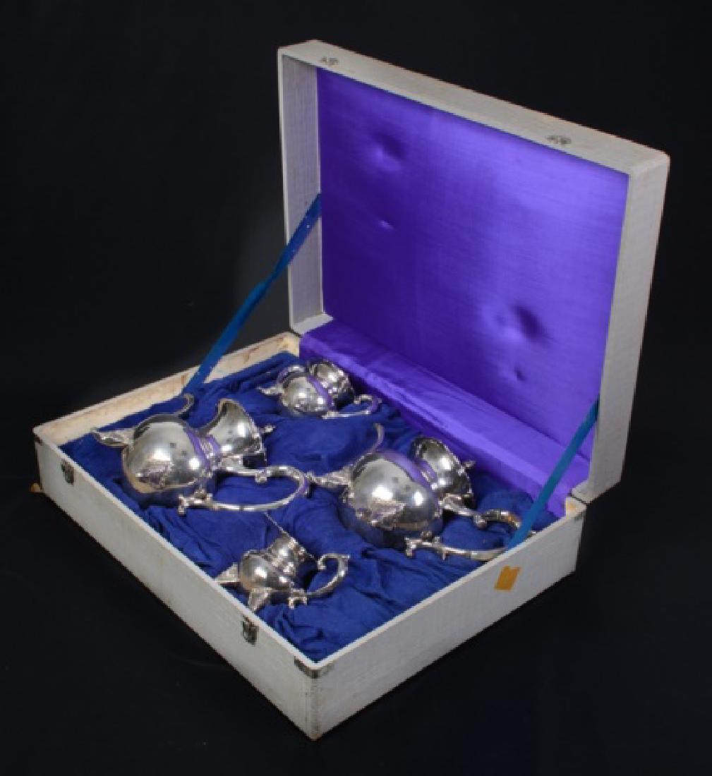 Sterling Tea & Coffee Service: Sterling four piece tea and coffee service to include: teapot, coffee pot, creamer and lidded sugar, all in a fitted box. All marked sterling 950. Coffee pot measures approximately 9-3/4" high, 12" wi