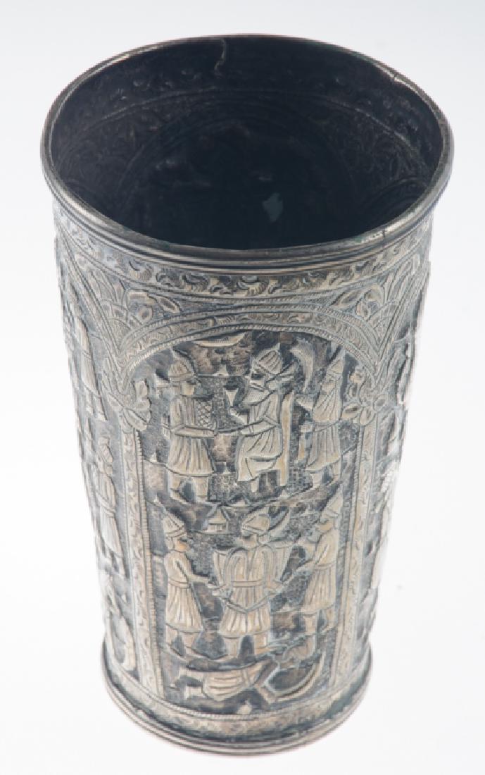 Ancient Ethiopian Silver Beaker: 800-900 silver, hand repousseed with paneled scenes of guards at a royal court and having applied rim and foot. Measures approximately 5-3.4" high, and 3-7/16 in diameter to the rim. Weighs approximat