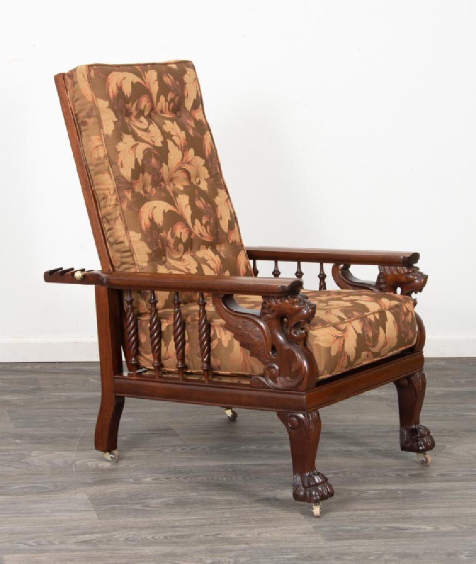 Morris Chair with Carved Griffon: Mahogany Morris reclining chair having shaped arm rests supported by carved winged griffon (griffin) to the front posts and twist turned spindles, with front carved paw feet, all resting on casters. I