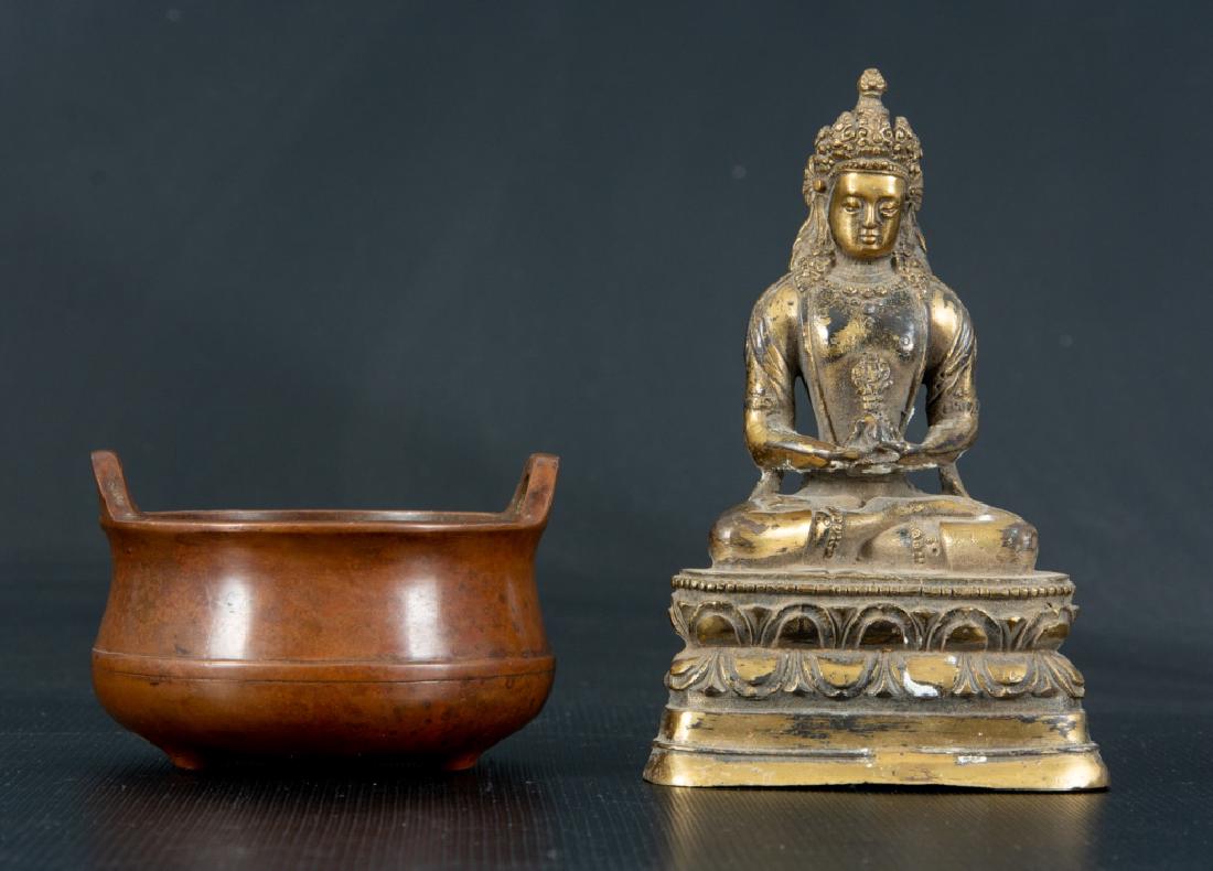 Asian Brass Buddha & Bronze Censer: Cast brass figure of Buddha seated on a lotus throne, together with a bronze double handed censer. Censer signed to the bottom. Buddha measures 6" high, 3-3/4" wide, and 2-3/8" deep. Censer measures 2