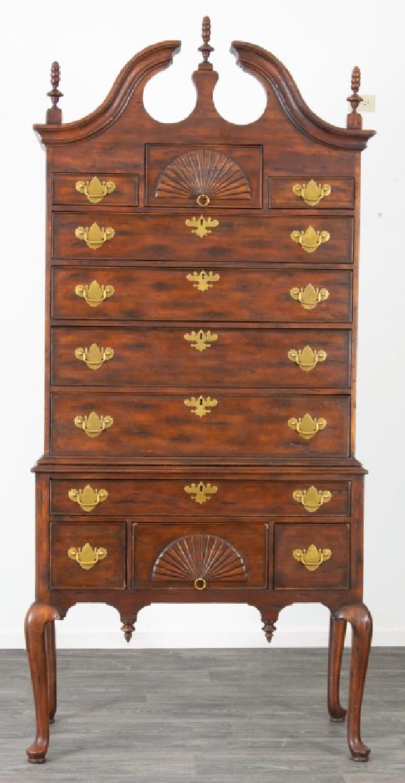Tall Chest on Chest / Highboy: Chest on chest / highboy in two parts. The upper section having a broken scroll pediment with flame finials, and fitted with seven drawers. The base fitted with four drawers, and resting on cabriole l