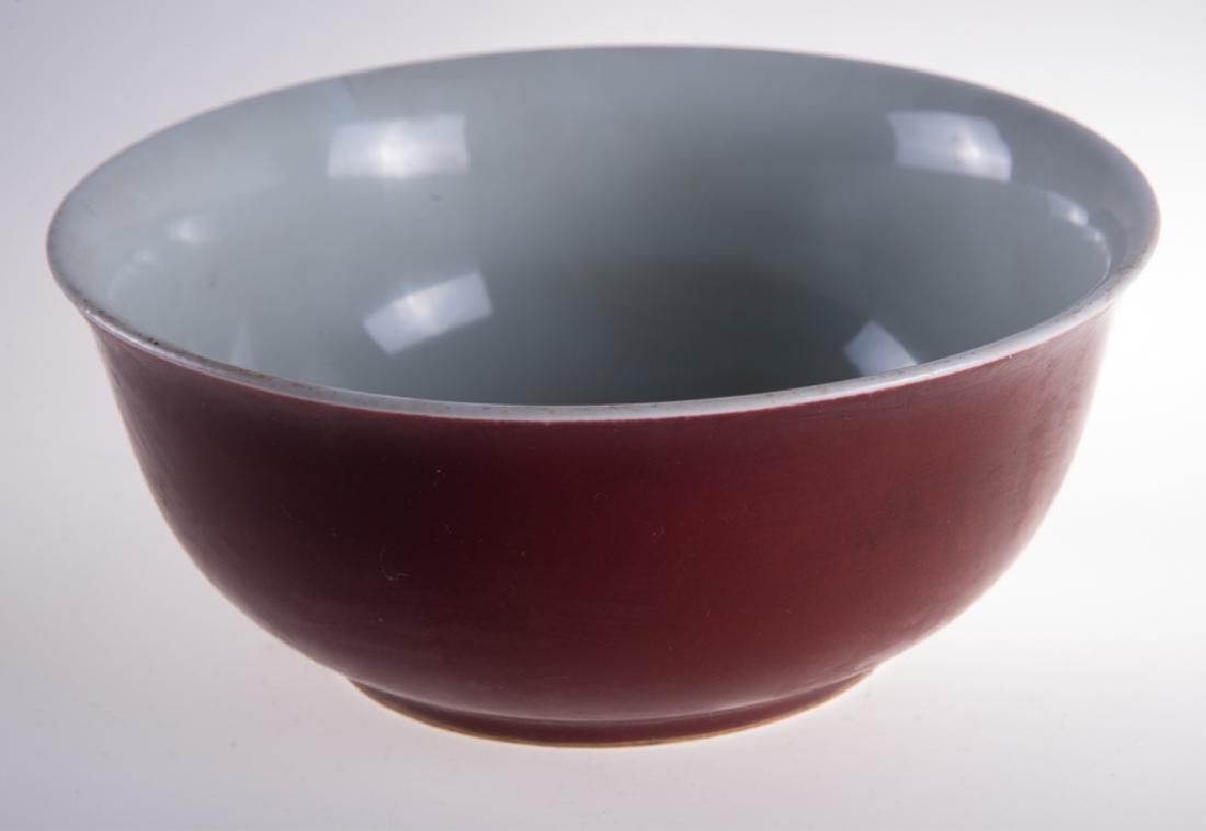 Chinese Sang de Boeuf Porcelain Bowl: Chinese Sang de Boeuf porcelain bowl bearing the K'ang Hsi mark underglaze blue. Hairline to rim. Measures approximately 3-1/4" high, 7-3/4" in diameter.