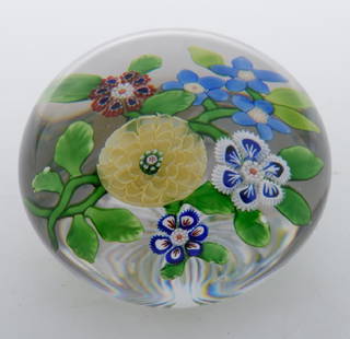 Antique Baccarat Glass Paperweight: Circa 1850 clear glass with star cut bottom containing a yellow pompon flower, six other flowers of cog and arrowhead canes and green leaves. Purchased from the Dunlop Collection in 1995.