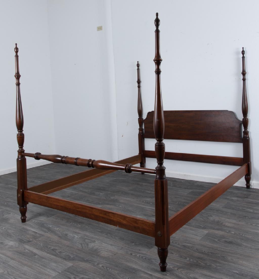 Pennsylvania House Cherry Poster Bed: Cherry bed having four turned posts with urn form finials, shaped headboard, and a turned footboard. Includes side rails. Marked Pennsylvania House to the back of headboard. In overall good condition