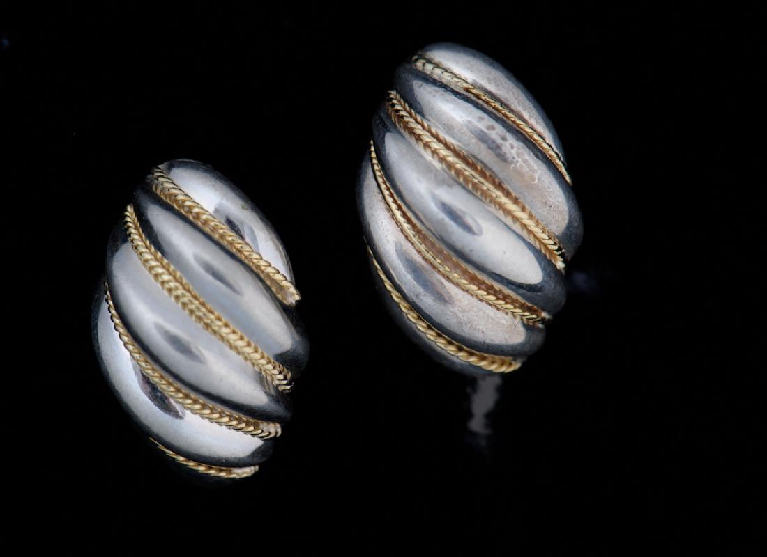 Tiffany & Co. Sterling & 18K Shrimp Earrings: Tiffany & Co. omega back shrimp earrings in sterling silver with 18k yellow gold rope swirl accents, 3/4" in total length and stamped "Tiffany & CO .925-750" to the back of each. Approximate weight of