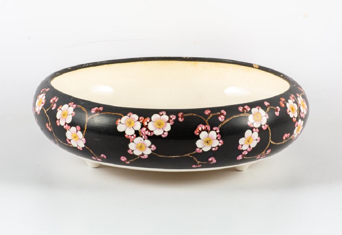 Famille Noir Nippon Bulb Pot: Late 19th / Early 20th century Famille Noir Nippon Bulb Pot . Black with pink blossoms, raised on three feet and marked Nippon to bottom. Nippon later became Noritake. Measures approximately 4" high, 