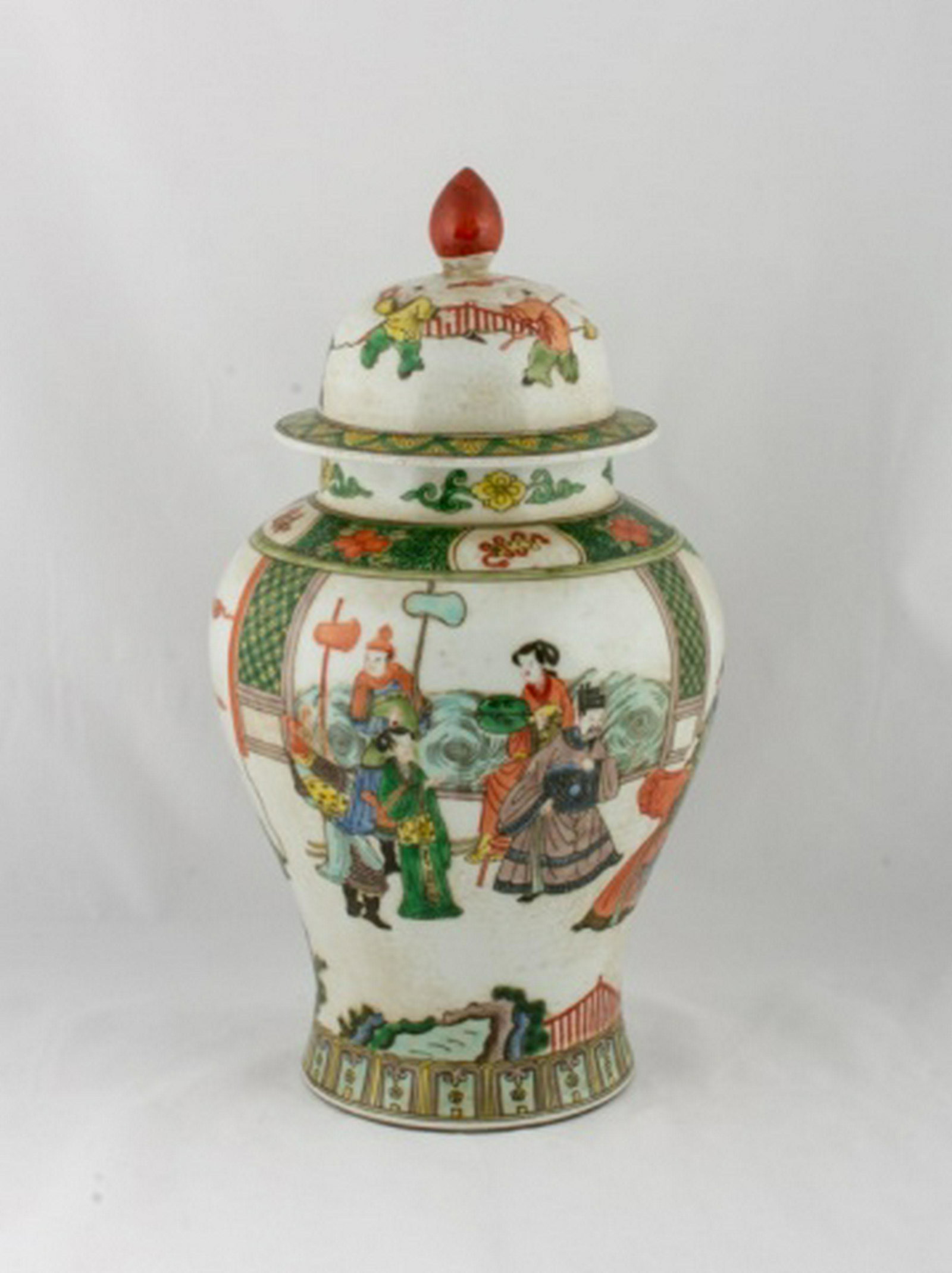 Chinese Porcelain Covered Jar: Chinese porcelain covered jar decorated with figures and foliate designs, and with a rust colored finial to the lid. Six Character blue mark to the bottom. Measures approximately 7" high. All sales ar