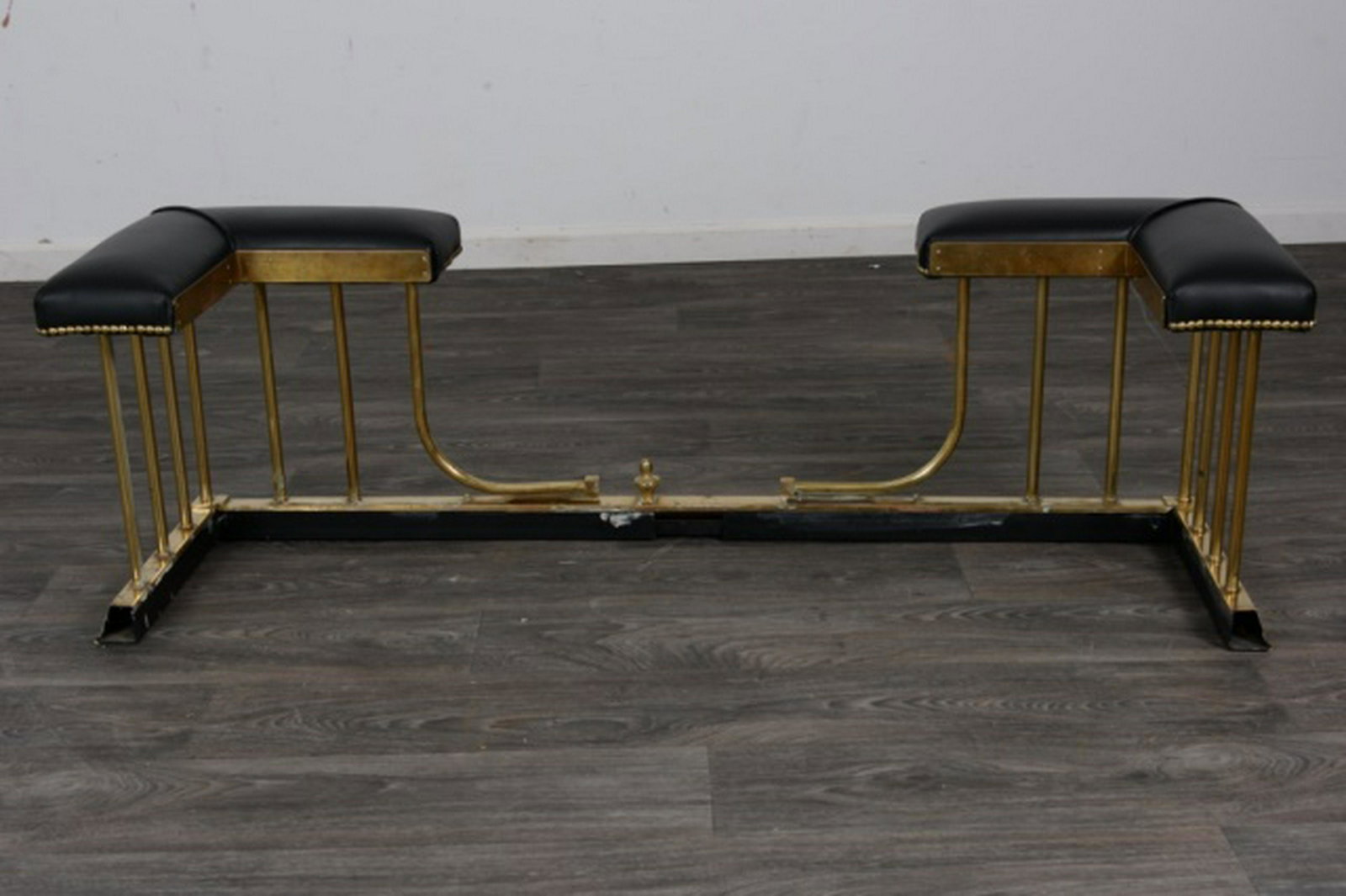 Brass and Leather Club Fender: brass leather club fender with brass spindles, center finial and leather seats. In overall good condition consistent with age and use. Measures approximately 18-1/2" high, 60" wide, 17" deep. All sale