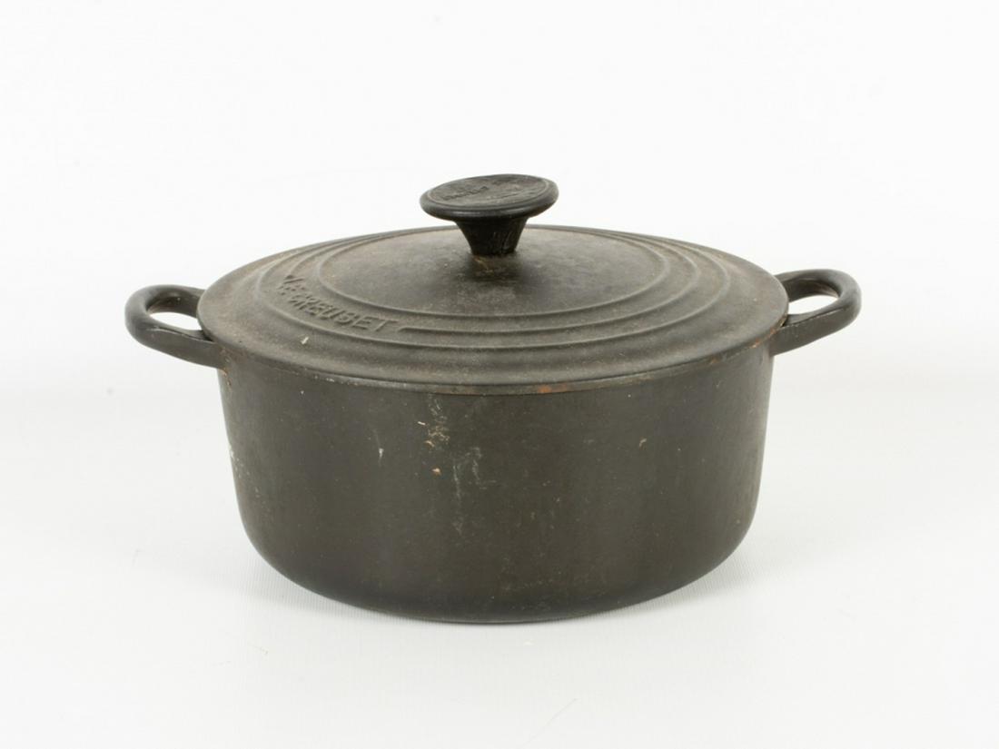 Le Creuset Round Dutch Oven: Black enameled cast iron round Dutch oven with lid. Marked to the bottom. Measures approximately 4" high (without lid), and 8-7/8" in diameter. Chipping to enamel. All sales are subject to Bremo Aucti