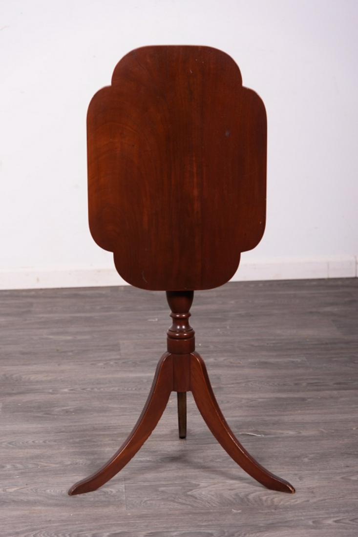 Hepplewhite Style Tilt Top Candlestand: Mahogany Hepplewhite Style Tilt Top Candlestand with shaped Type Turned Shafts and Resting on Saber legs. In overall good condition consistent with age and use. Measures approximately 30-1/2" high, 22