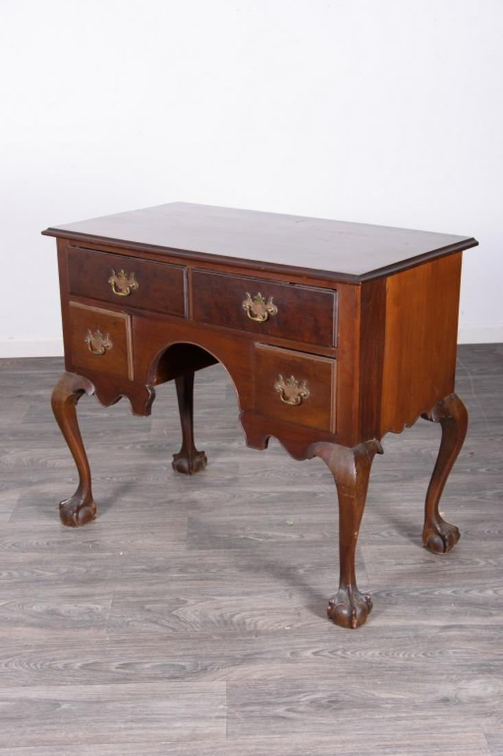 Mahogany Lowboy: Having two top drawers flanked by two lower drawers with brass pulls. Cabriole legs with ball and claw feet. In overall good condition consistent with age and use. Measures approximately 32" high, 38"