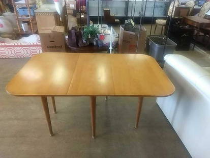 Maple Drop Leaf Dining Table: Drop leaf dining table, maple wood. In overall good condition consistent with age and use. Measures approximately 38-1/4" high, 62-1/4" fully extended.All sales are subject to Bremo Auctions Terms & C