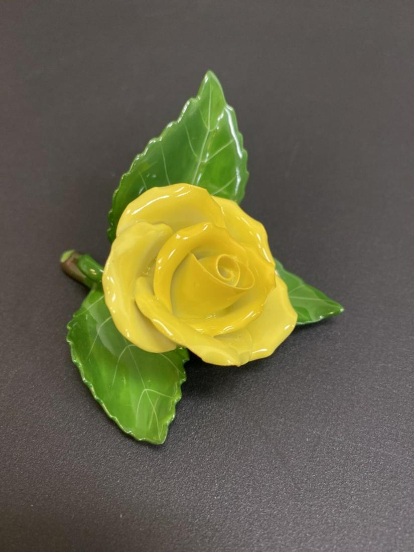 Herend Porcelain Flower: Yellow rosebud resting on leaves. Mark to bottom. Measures approximately 1-3/4" high and 3" wide.All sales are subject to Bremo Auctions Terms & Conditions. Please review before bidding.