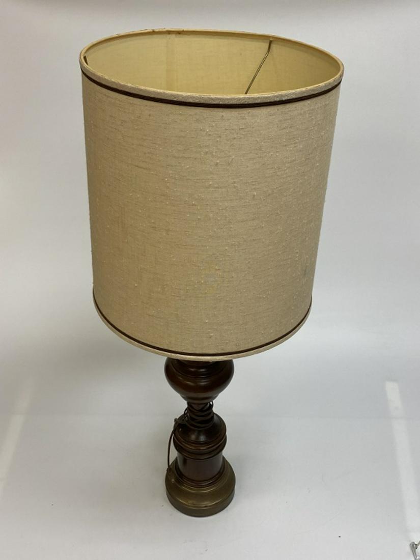 Turned Wooden Lamp: With metal base. Measures approximaltey 39" high to top of shade and approximately 33" to top of harp. The shade is 16-1/8" in diameter. All sales are subject to Bremo Auctions Terms & Conditions. Ple