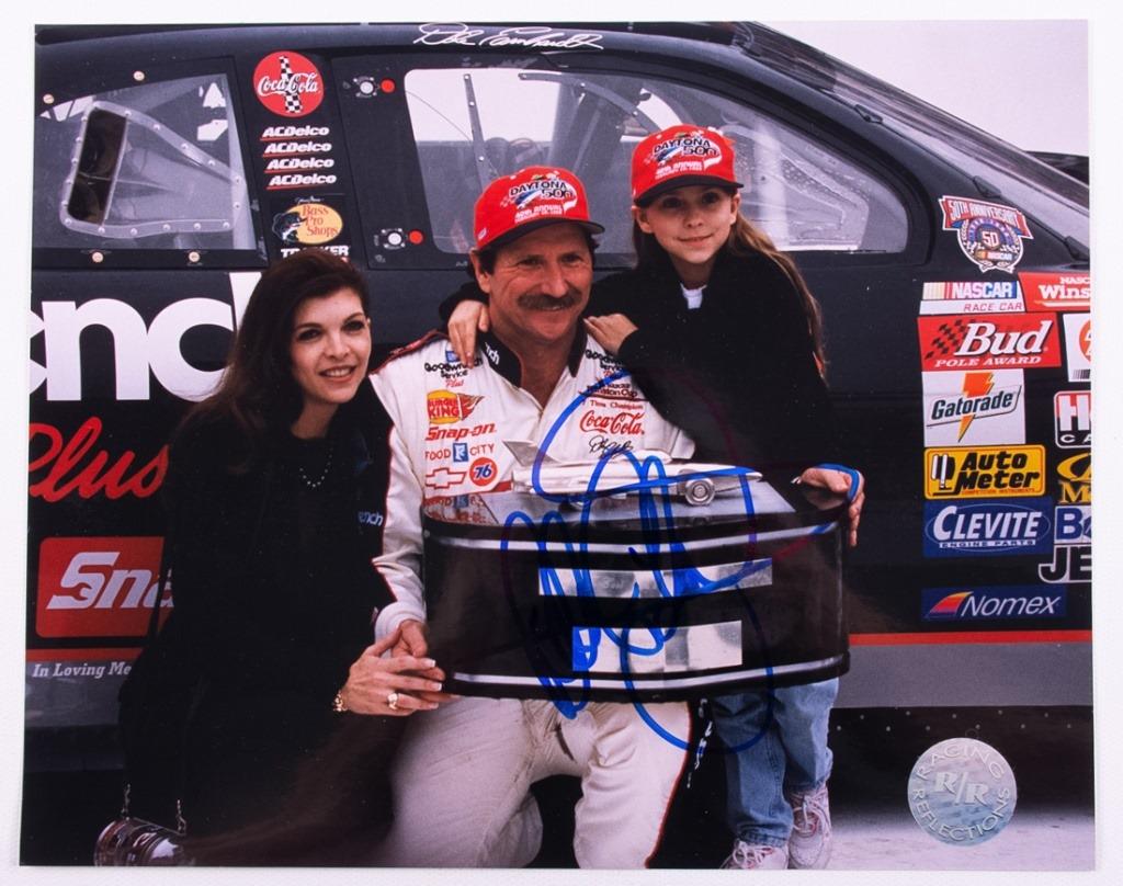 NASCAR Dale Earnhardt Autographed Photo: Dale Earnhardt autographed Racing Reflections 8 x 10 colored photo, depicting Dale Earnhardt victorious with trophy and wife Teresa and daughter. With Racing Reflections hologram sticker to the lower 
