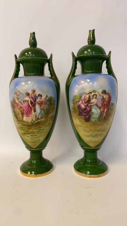 Pair of Royal Crown Urns: Two green painted urns with painted figures ti the front of each. Both stamped to bottom. Measures approximately 14-1/2" high.