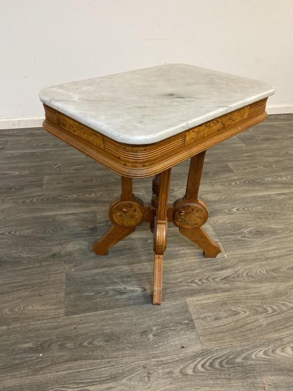 Marble Top Side Table: Wood carved frame. Measures approximately 28-1/4" high, 26" wide and 18" deep.