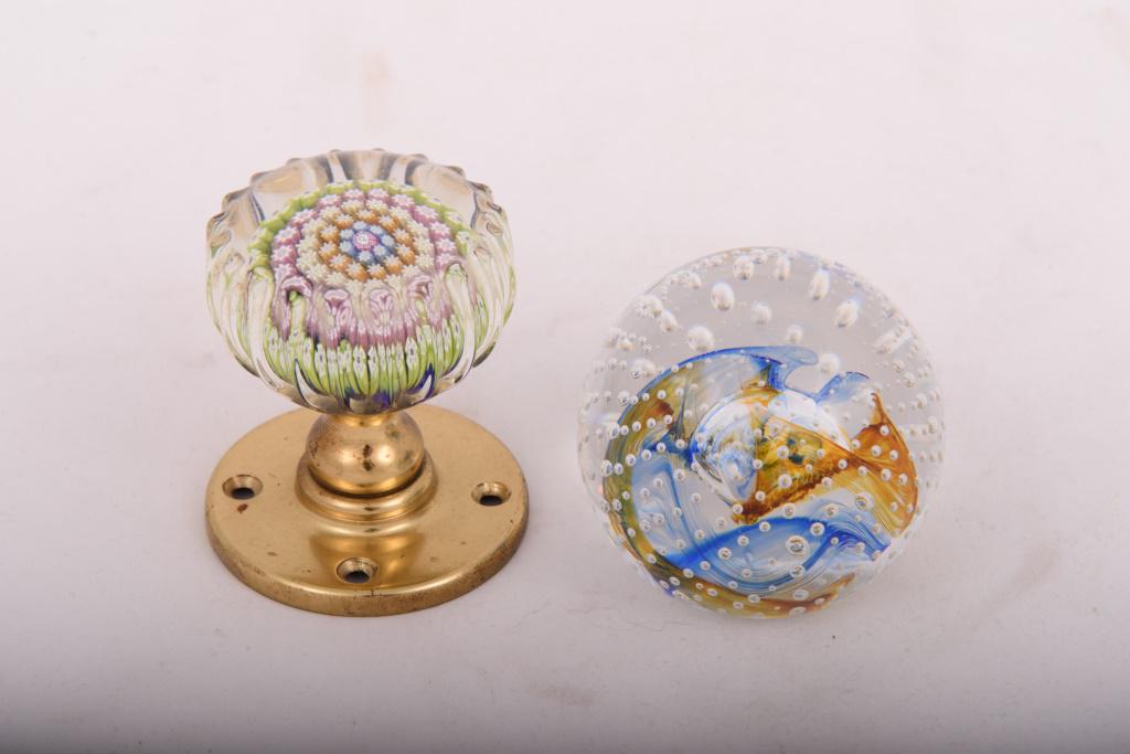 Two Scottish Glass Paperweights: Caithness ball with bubbles and blue and yellow swirls and a Perthshire with concentric cane circles and fluted sides, mounted as a door knob. Ball measures 2-3/8" high, door knob measures 2-7/8" high