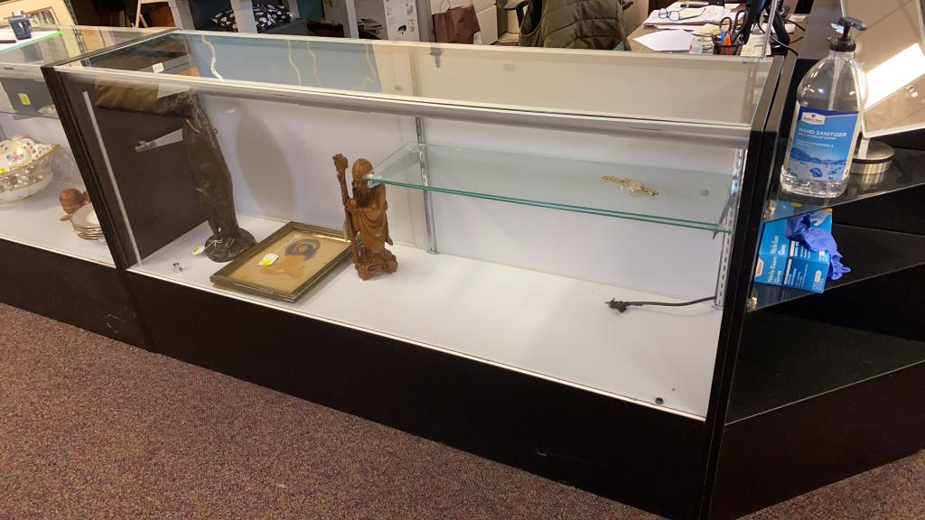 Glass Display Case: Two shelf display case with internal lighting. Photograph is of similar case. In overall good condition. Measures approximately 38" high, 70" wide and 17-1/2" deep.