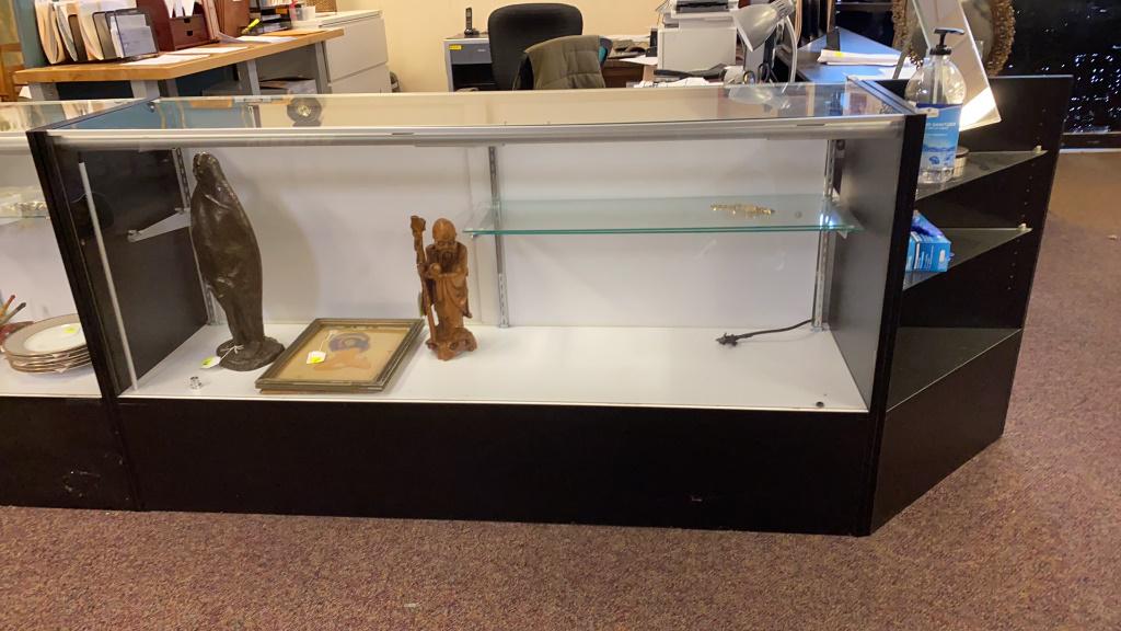 Glass Display Case: Two shelf display case with internal lighting. Photograph is of similar case. In overall good condition. Measures approximately 38" high, 70" wide and 17-1/2" deep.