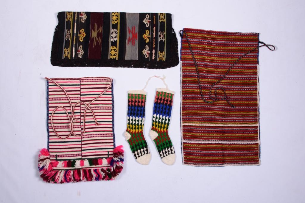 Four Piece of Ethnic Macedonian Clothing: Three finely woven aprons with stripes or area motifs and with braided yarn ties and a pair of heavy knit wool socks.