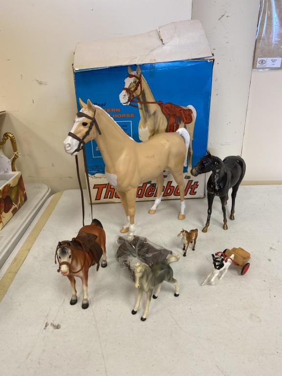 Johnny West's Thunderbolt: In original box with bridle, rifle holster, saddle and blanket along with a painted metal horse (some loss to paint) and assorted plastic horses. Box measures approximately 15" high and 14" wide.