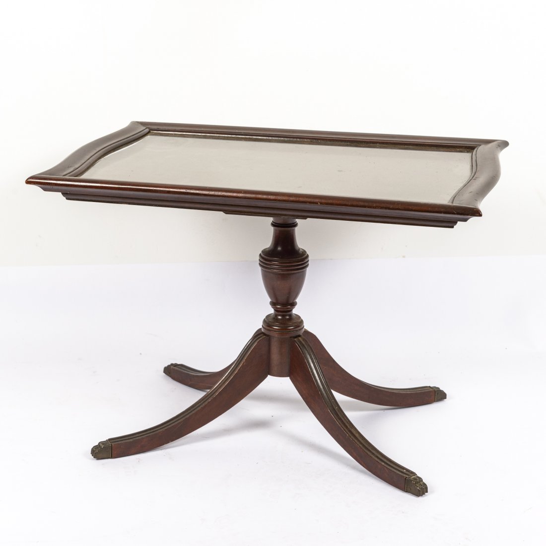 A Mahogany Coffee Table with Glass Tray Top: Having pedestal base and four legs with brass feet. Height: 19 1/4" Width: 27 3/4" Depth: 19 1/4"