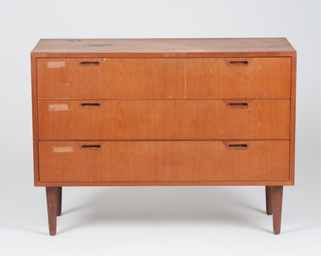 A Raymor Danish Modern Dresser: Having three drawers and turned tapered legs. Some loss to finish on drawer faces and top. Height: 29" Width: 39 1/4" Depth: 15 3/4"