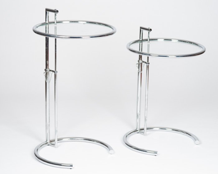 A Pair of Eileen Gray Chrome and Glass Side Tables: Height adjustable. Diameter: 20"